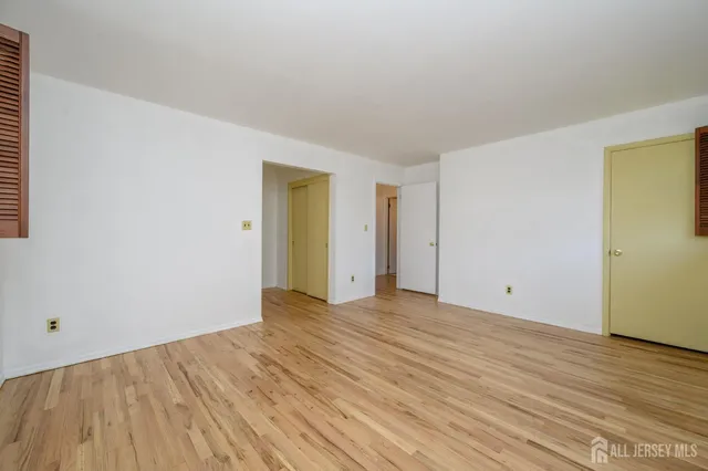a view of an empty room and wooden floor