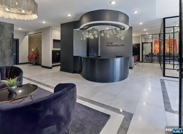 a kitchen with stainless steel appliances kitchen island granite countertop a table and chairs in it
