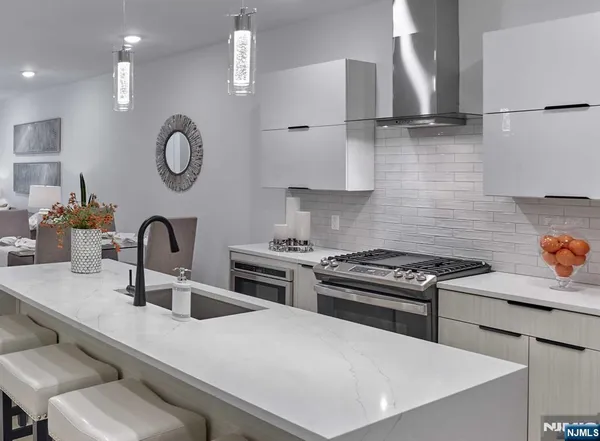 a kitchen with stainless steel appliances a sink a stove and a refrigerator