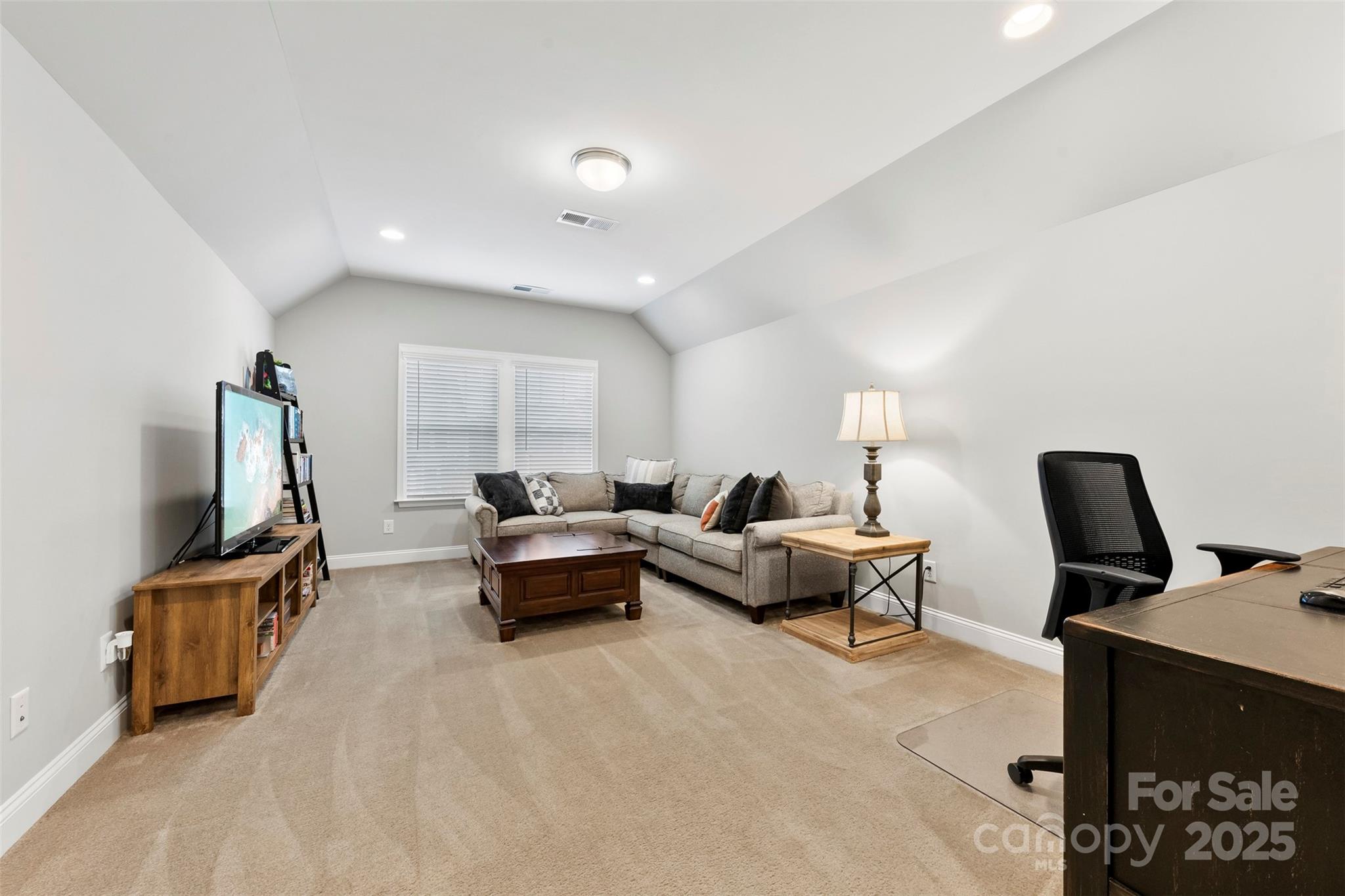 6261 Six String Court Fort Mill, SC 29708 - Photo 12 of 31 a living room with furniture a flat screen tv and a window