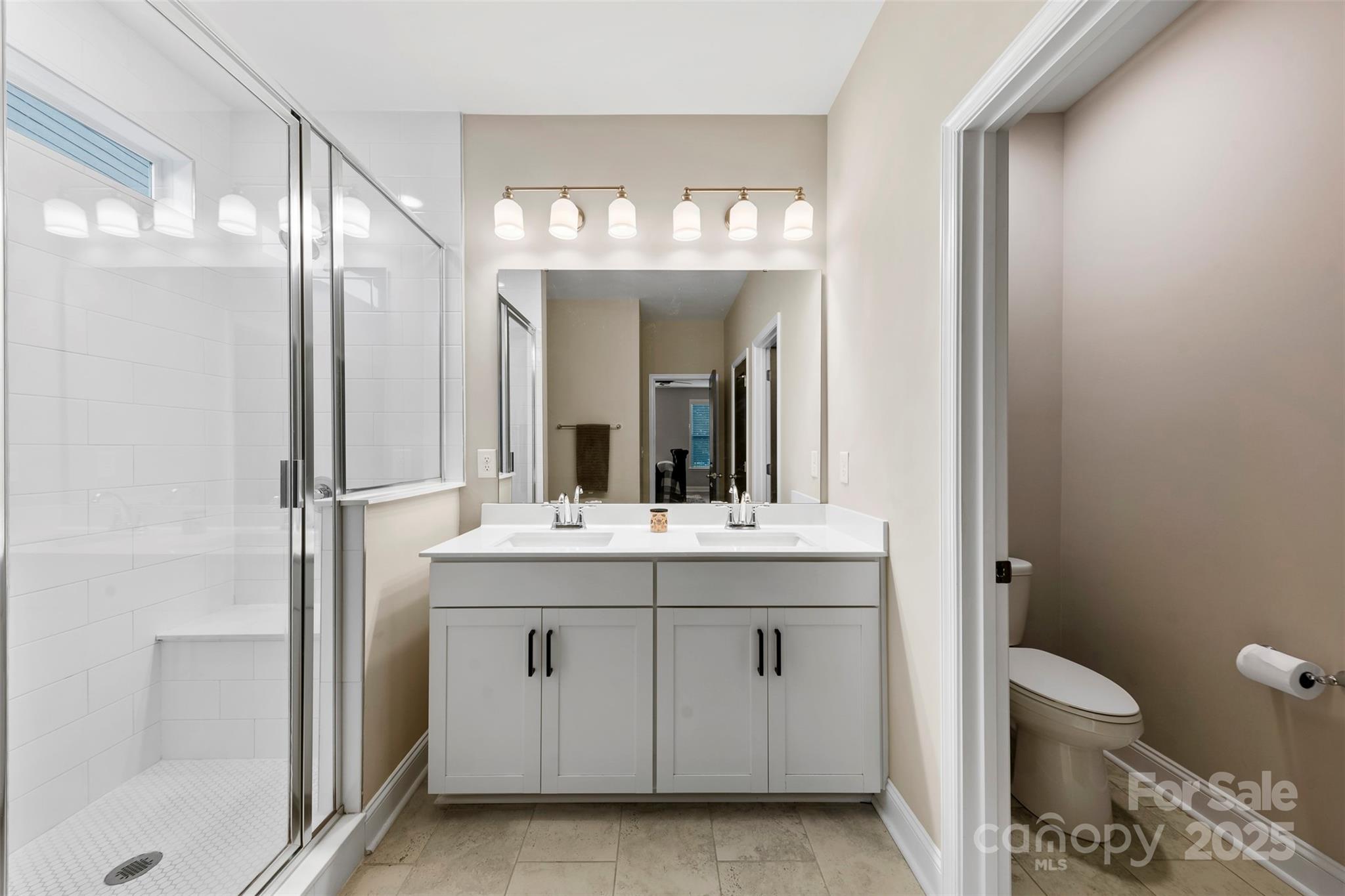 6261 Six String Court Fort Mill, SC 29708 - Photo 17 of 31 a bathroom with a sink a toilet and a mirror