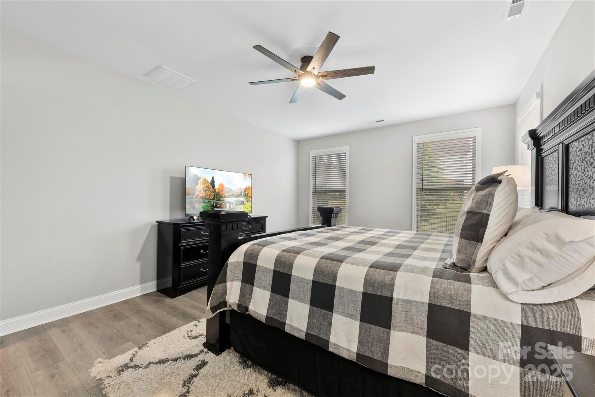 6261 Six String Court Fort Mill, SC 29708 - Photo 19 of 31 a bedroom with a bed and a chandelier