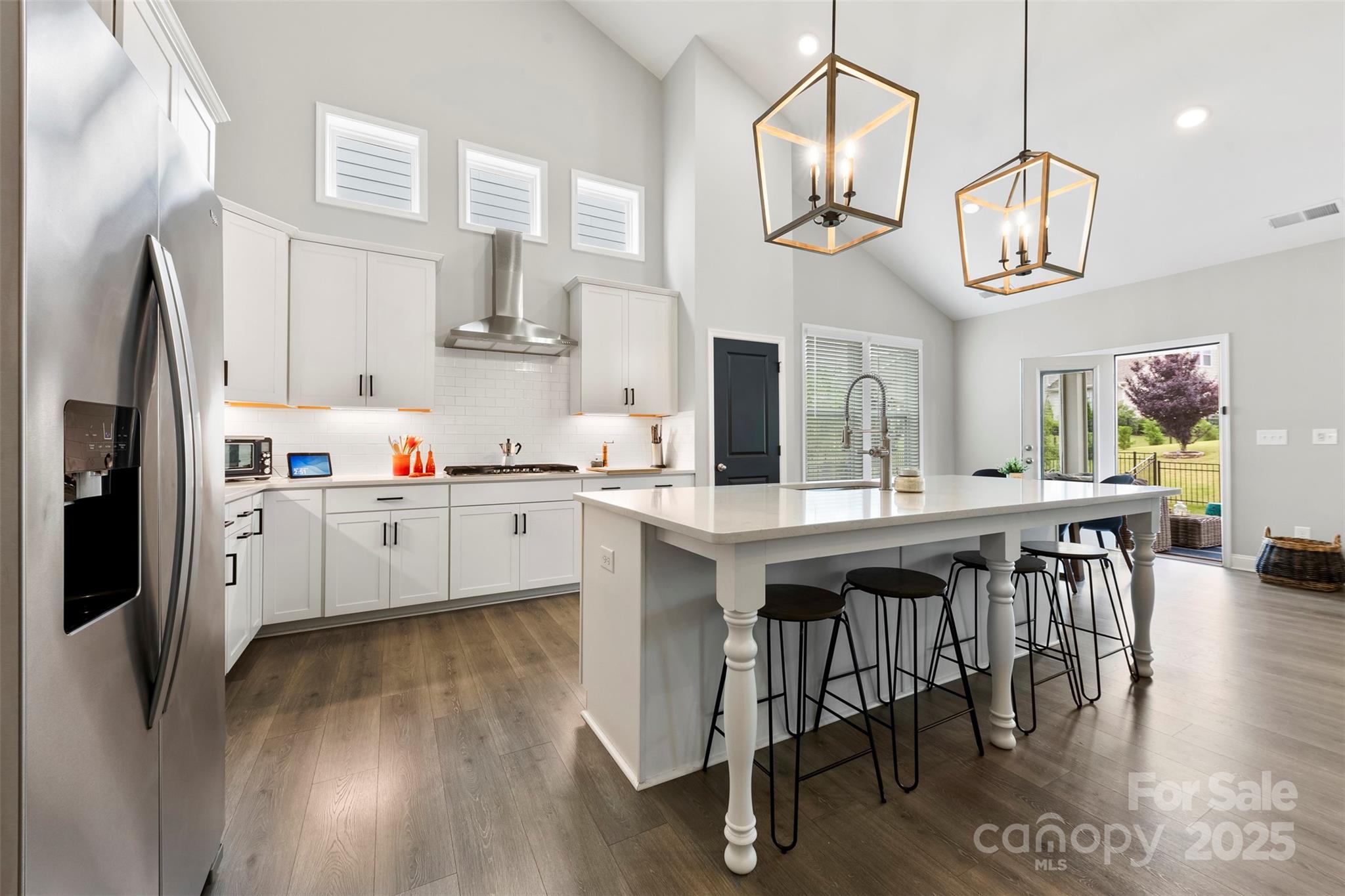 6261 Six String Court Fort Mill, SC 29708 - Photo 5 of 31 a kitchen with stainless steel appliances granite countertop a kitchen island a stove a table and chairs in it