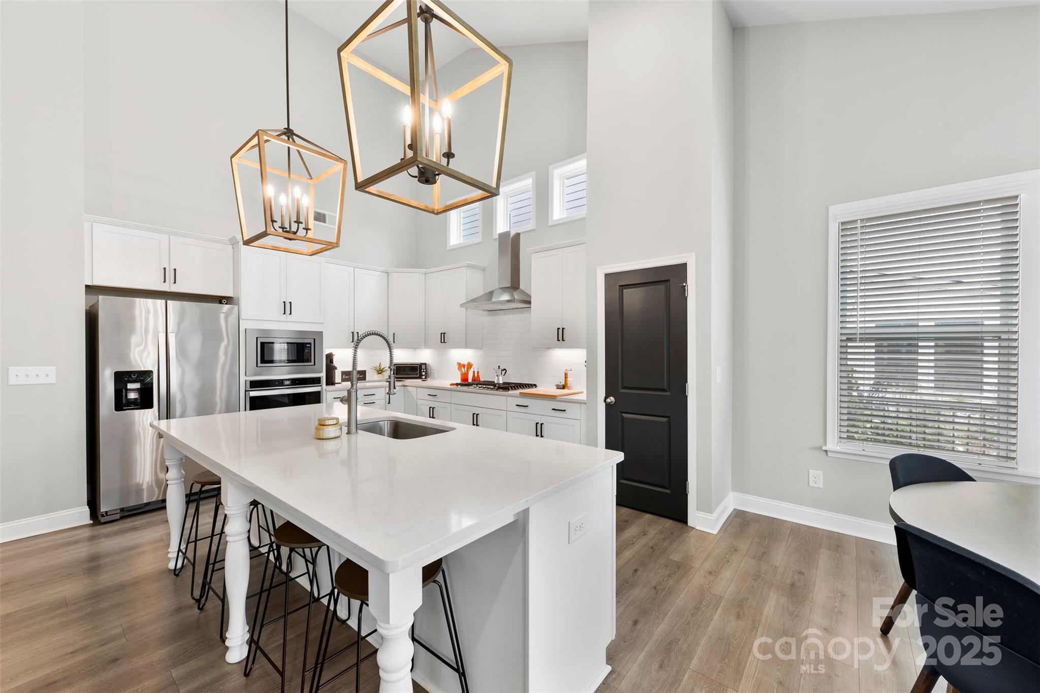 6261 Six String Court Fort Mill, SC 29708 - Photo 6 of 31 a kitchen with stainless steel appliances granite countertop a table chairs a refrigerator and a window