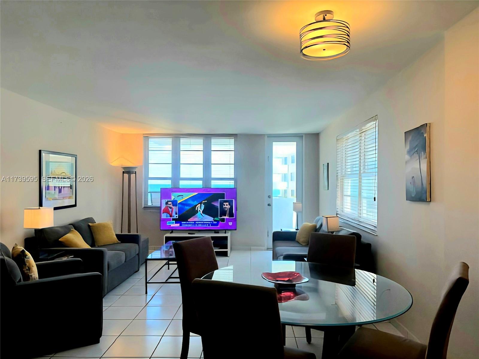 100 Lincoln Road, Unit 821 Miami Beach, FL 33139 - Photo 5 of 33 a living room with furniture a rug and a window