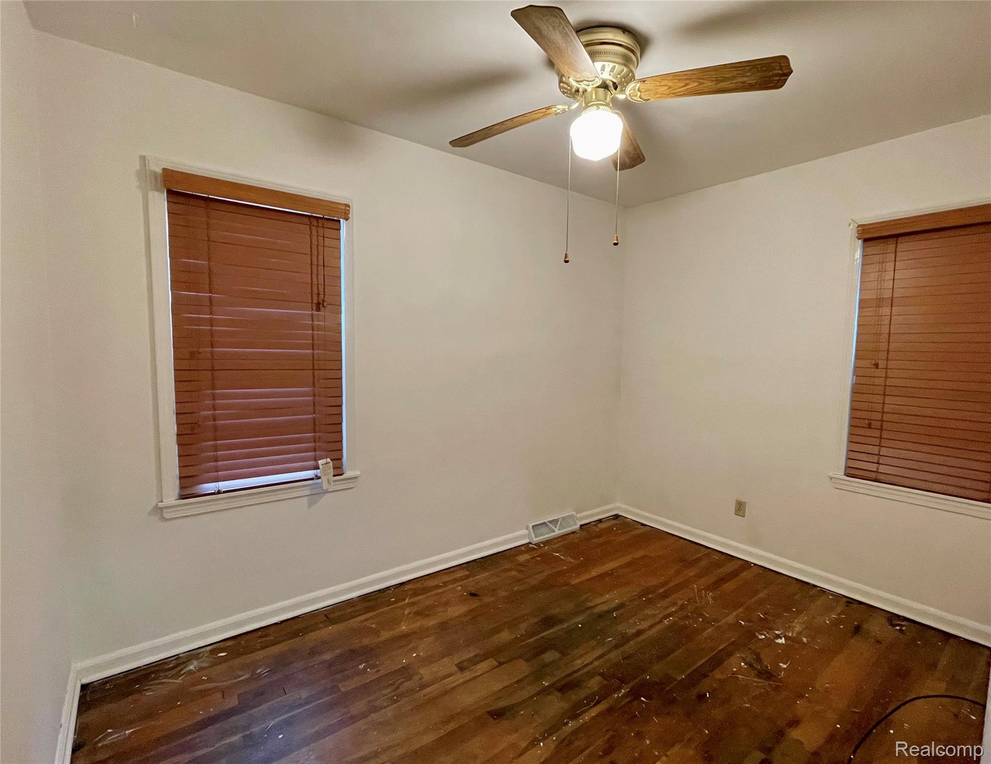 10444 Quirk Road Belleville, MI 48111 - Photo 10 of 35 Main floor bedroom. Original hardwood floors exposed, waiting to be refinished