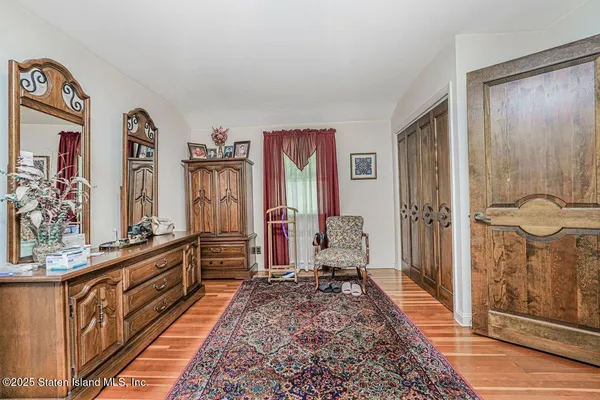 a view of an empty room with window and cabinet