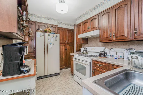 a kitchen with stainless steel appliances granite countertop a stove sink and cabinets