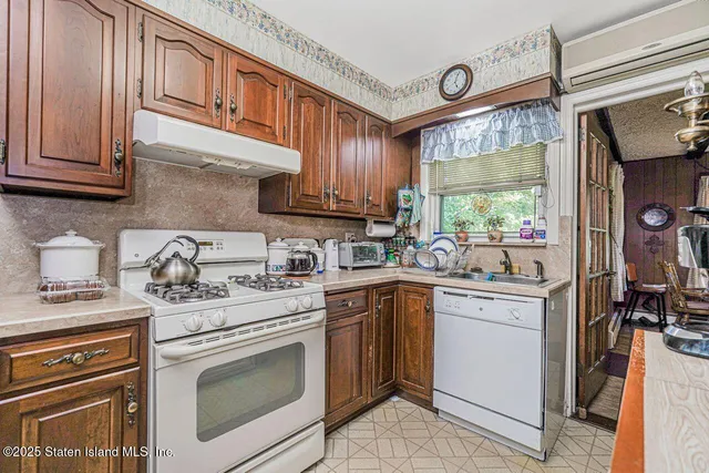a kitchen with stainless steel appliances granite countertop a stove and a sink