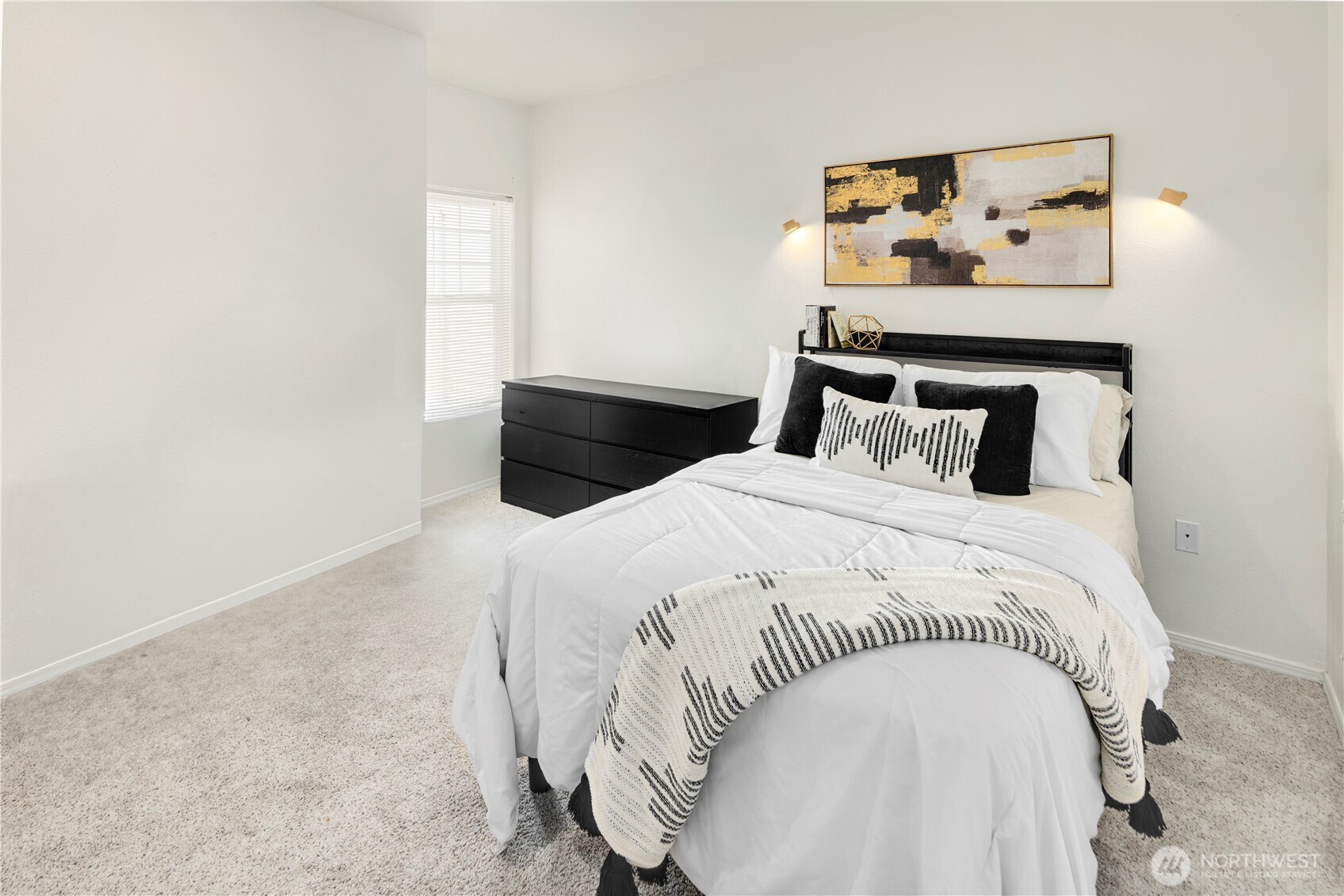 14120 Southeast 171st Way, Unit C303 Renton, WA 98058 - Photo 9 of 21 a bedroom with a bed and painting on the wall