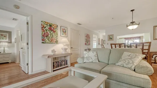 a dining room with furniture a window and kitchen view