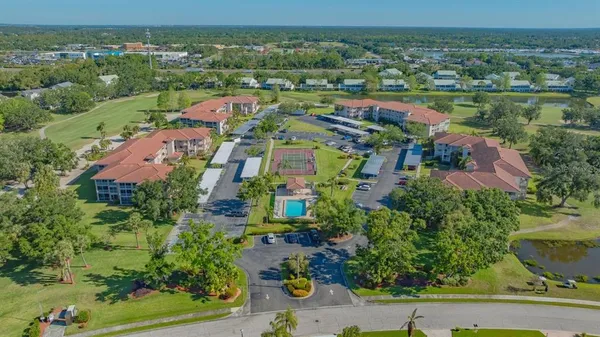 an aerial view of residential houses with outdoor space and street view
