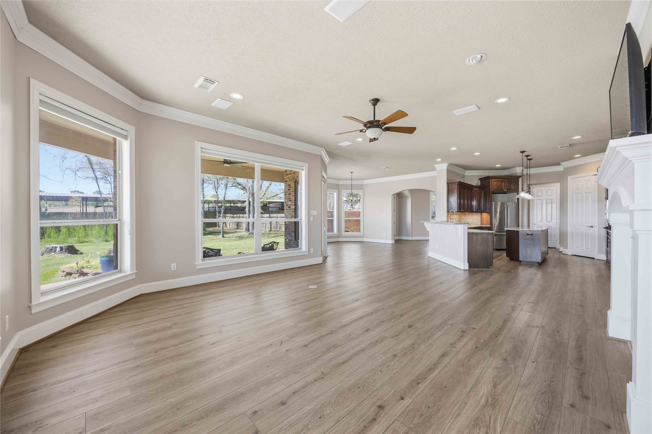 1930 Old River Road Montgomery, TX 77356 - Photo 10 of 49 To the side of the kitchen is the living room with even more windows that offer a great view of the pool.