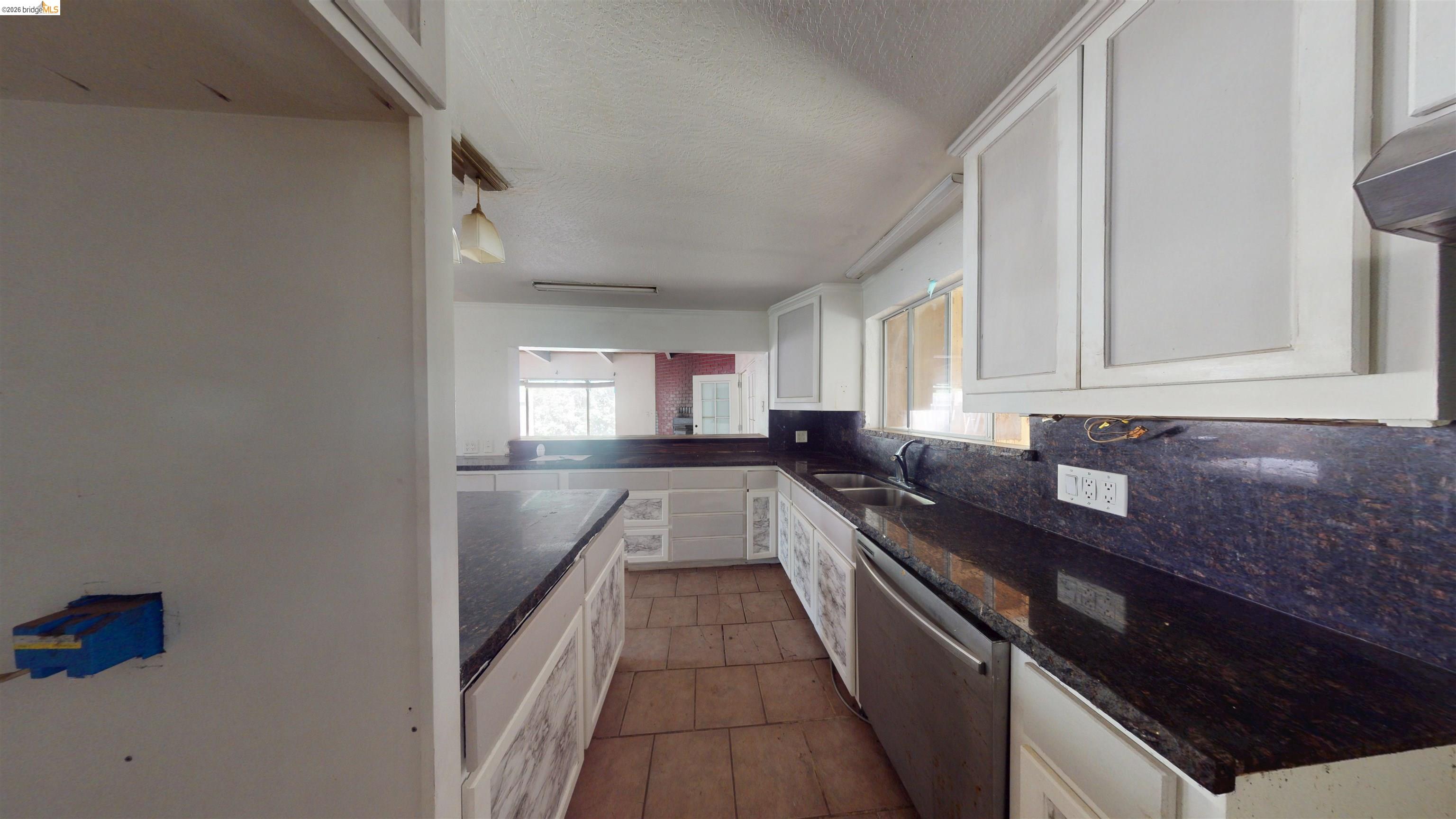 20231 Hidden Acres Road Sonora, CA 95370 - Photo 13 of 25 Kitchen featuring white cabinetry, dark stone countertops, tile flooring, and stainless steel appliances