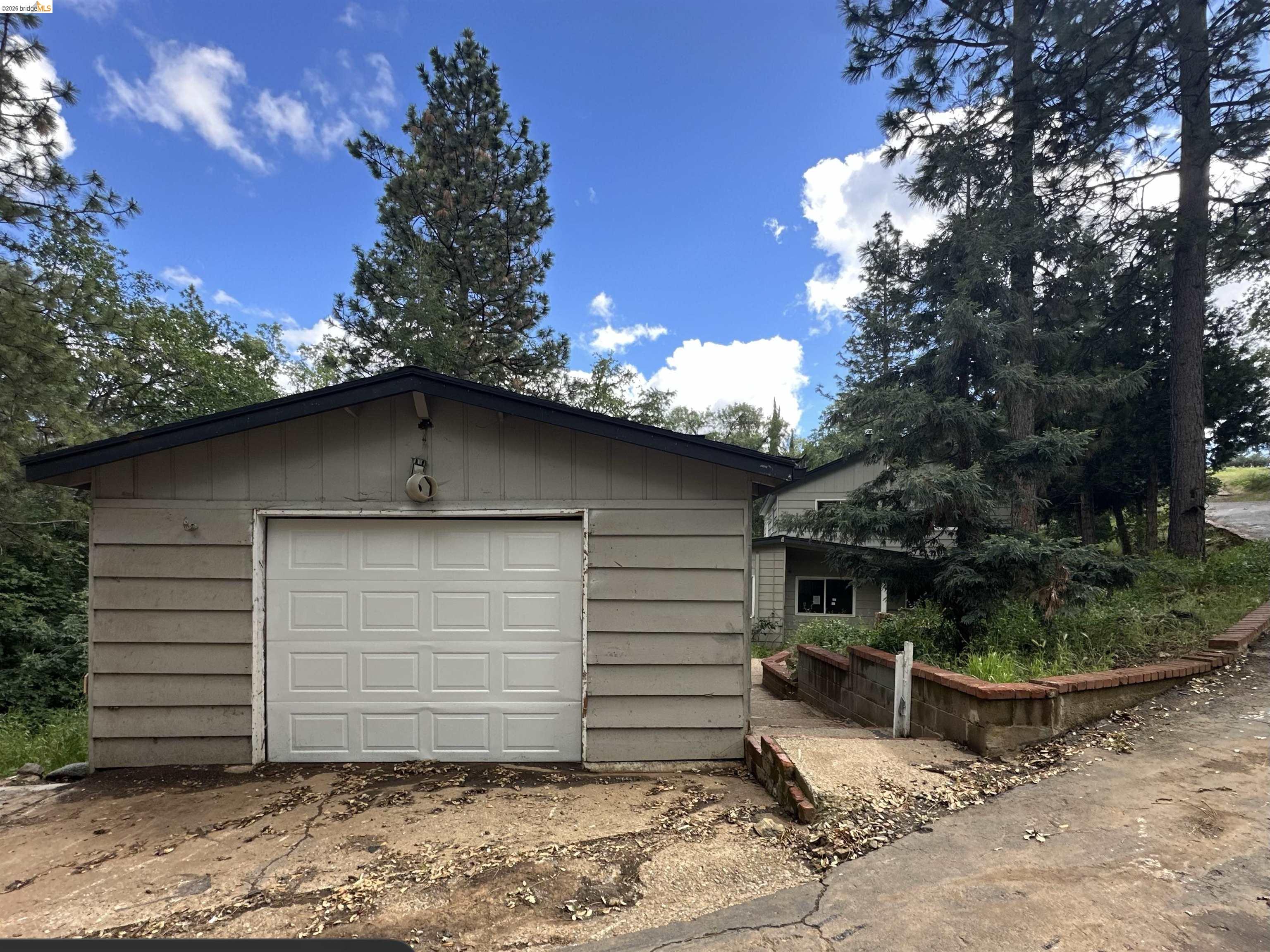 20231 Hidden Acres Road Sonora, CA 95370 - Photo 24 of 25 Attached garage featuring a panel-style door