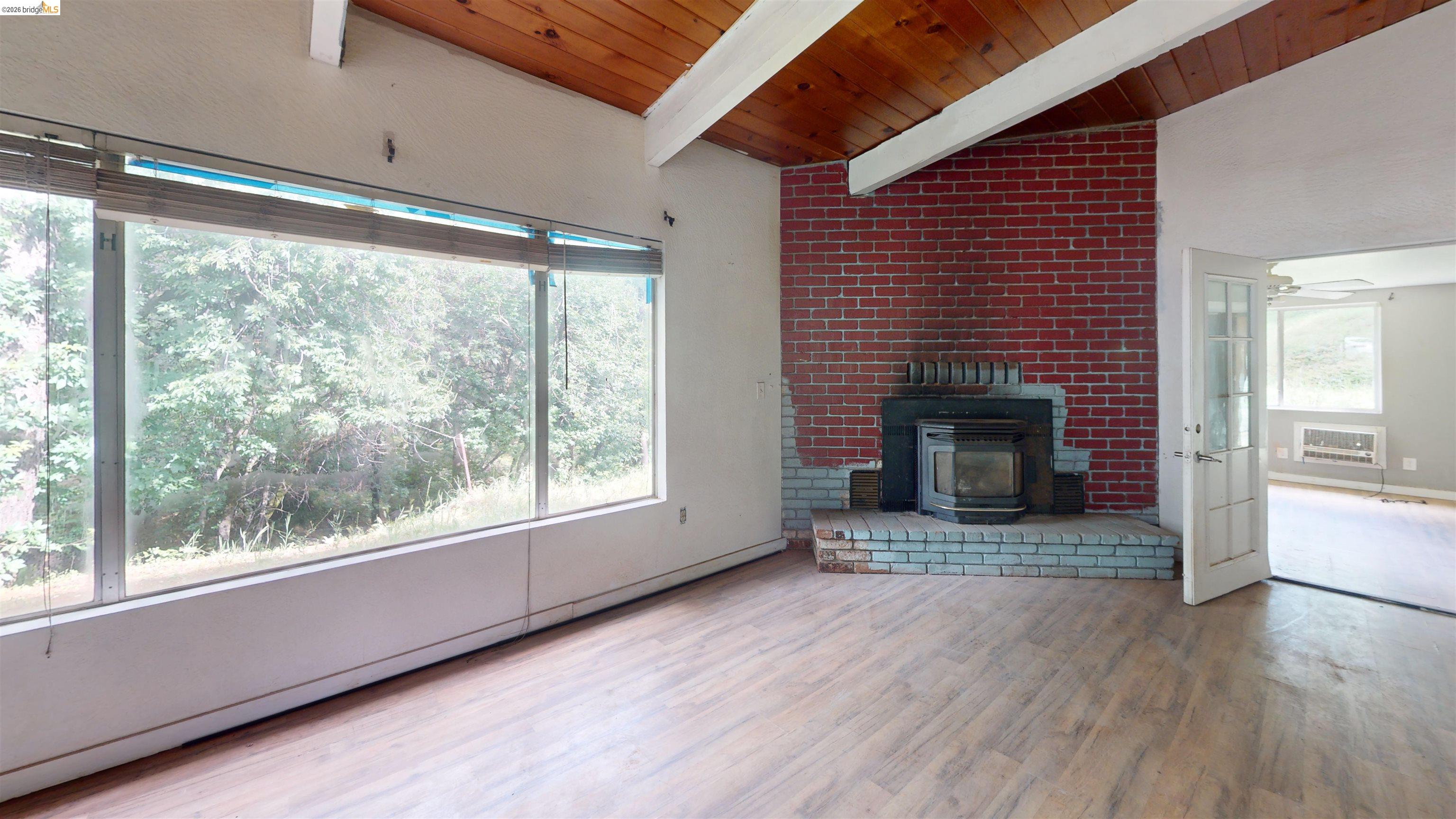 20231 Hidden Acres Road Sonora, CA 95370 - Photo 9 of 25 Vaulted ceiling with wood-finish planks and exposed beams