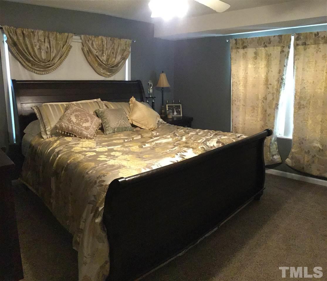 754 Drag Strip Road Benson, NC 27504 - Photo 11 of 16 a bed sitting in a bedroom next to a window