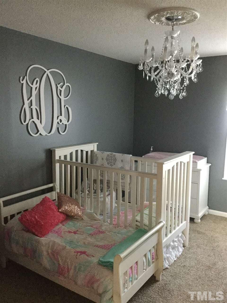754 Drag Strip Road Benson, NC 27504 - Photo 12 of 16 a bedroom with furniture and a chandelier