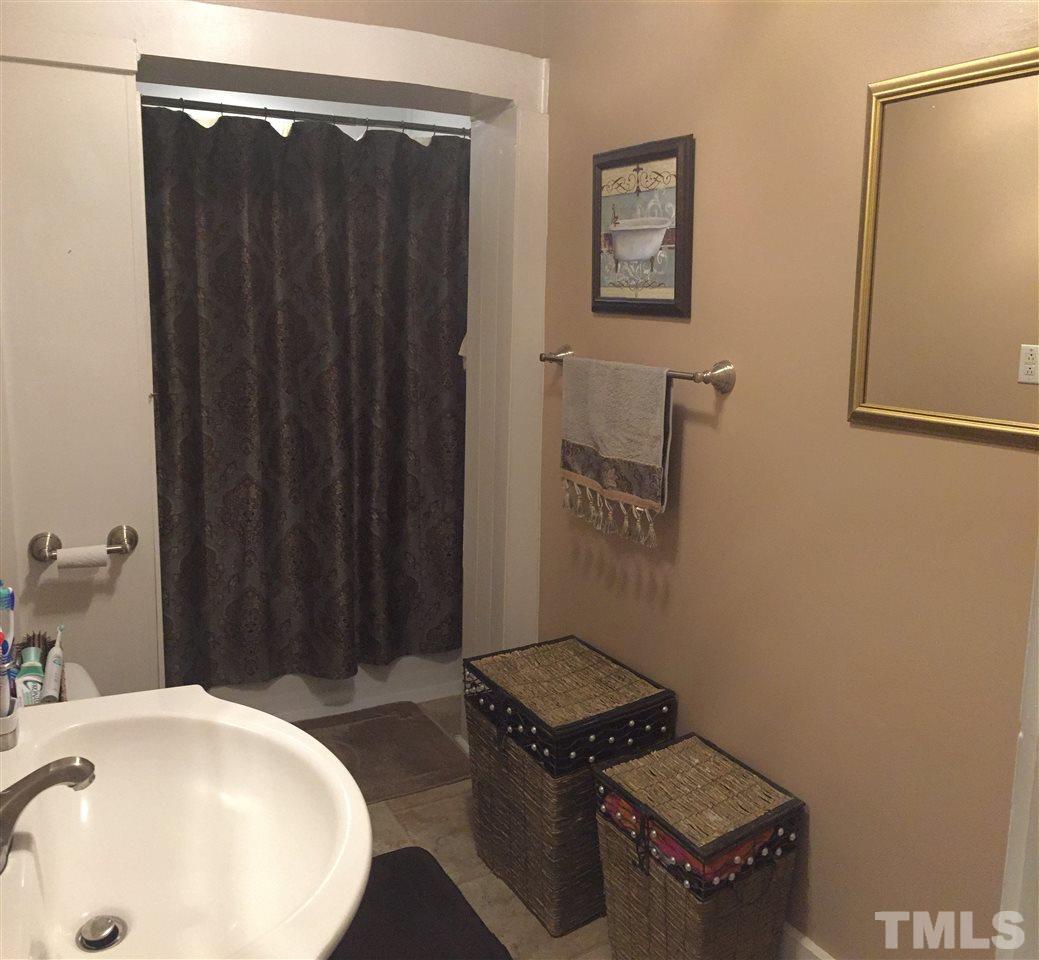 754 Drag Strip Road Benson, NC 27504 - Photo 14 of 16 a bathroom with a sink and a mirror