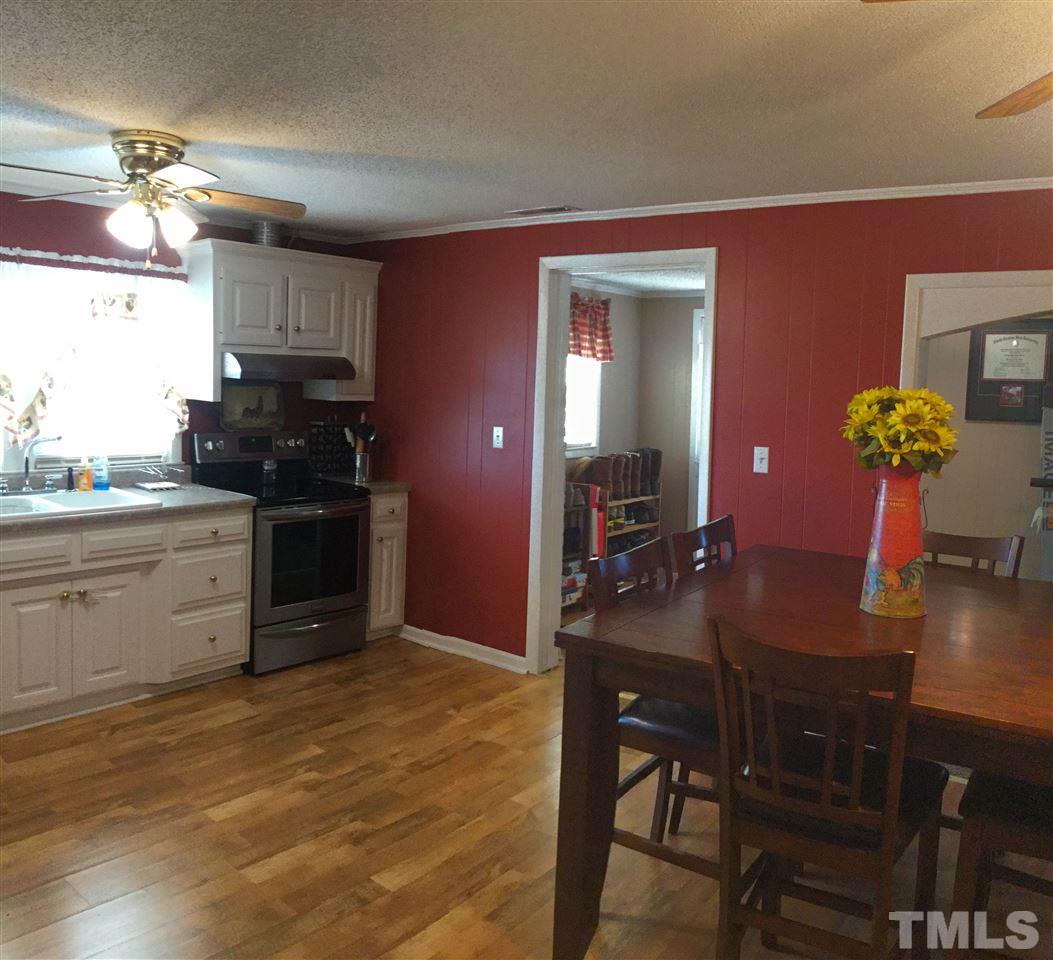 754 Drag Strip Road Benson, NC 27504 - Photo 6 of 16 a kitchen with a table and chairs in it