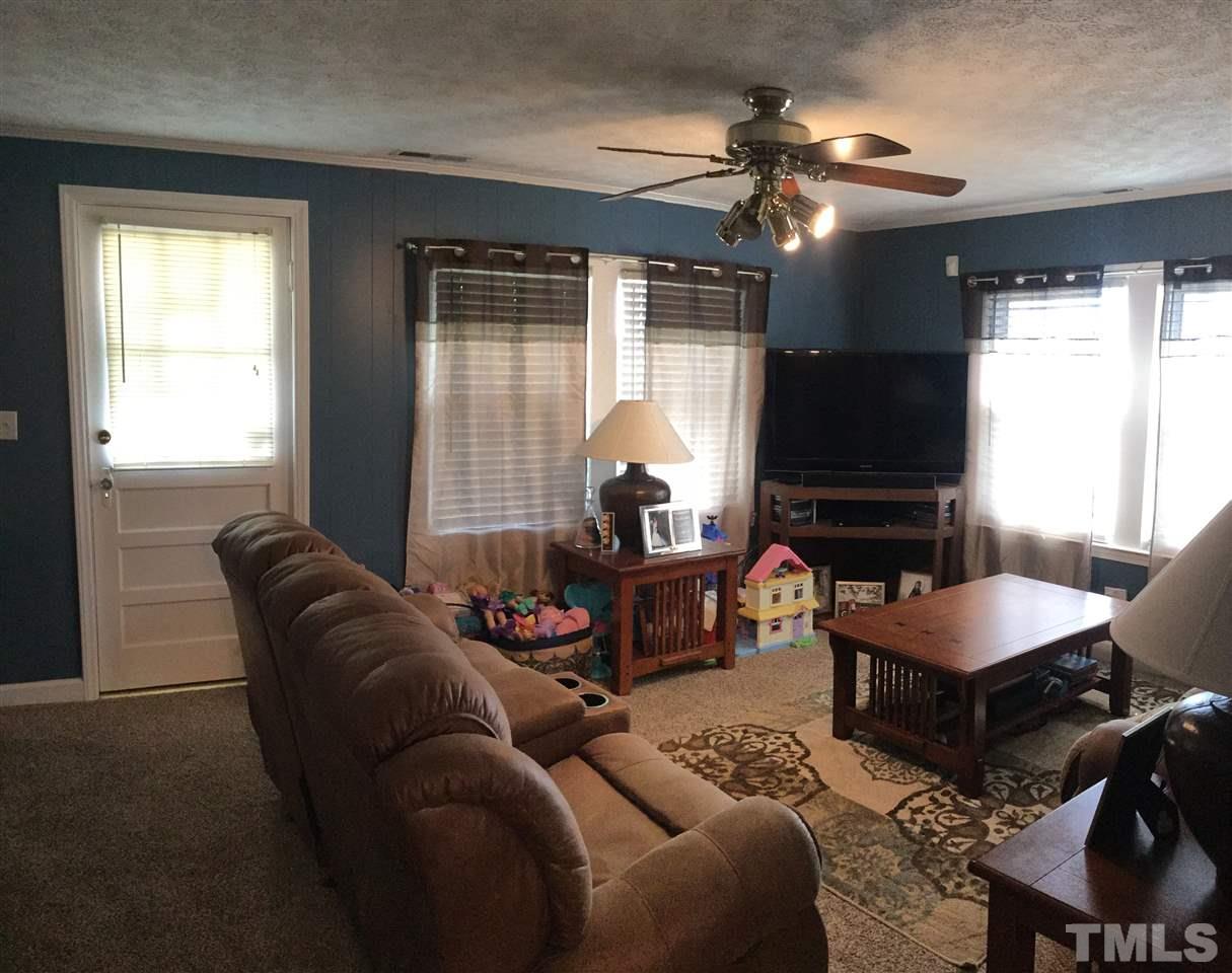 754 Drag Strip Road Benson, NC 27504 - Photo 8 of 16 a living room with furniture and a flat screen tv