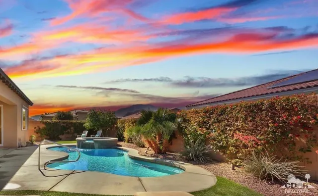 a view of a swimming pool with an outdoor seating and a yard