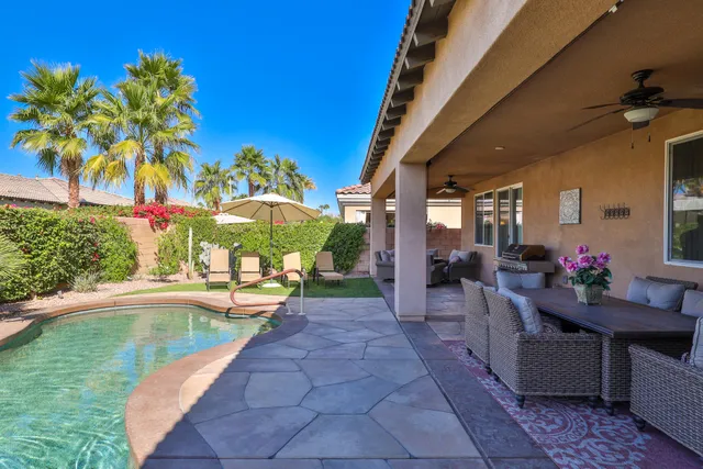 a view of a swimming pool with sitting area