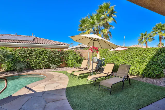 a view of a tables and chairs under an umbrella