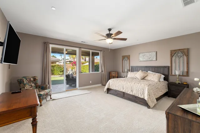 a spacious bedroom with a large bed and a window