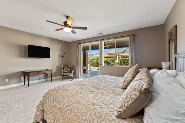 a bed sitting in a bedroom next to a window