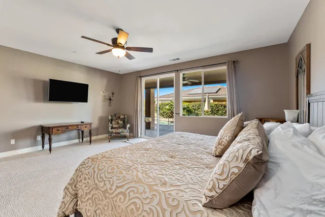 a bed sitting in a bedroom next to a window