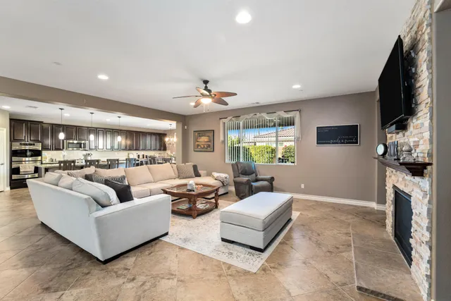 a living room with fireplace furniture and a flat screen tv