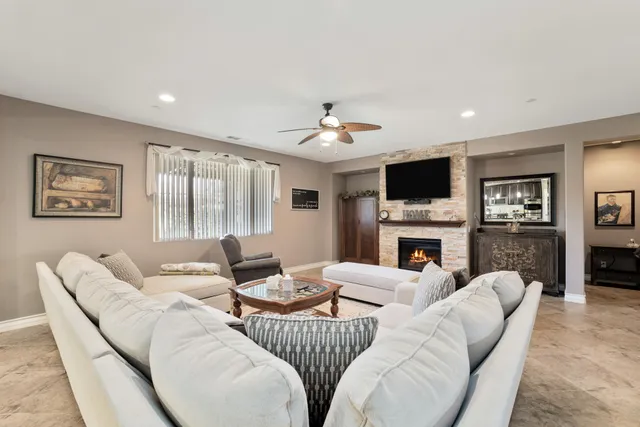 a living room with fireplace furniture and a flat screen tv