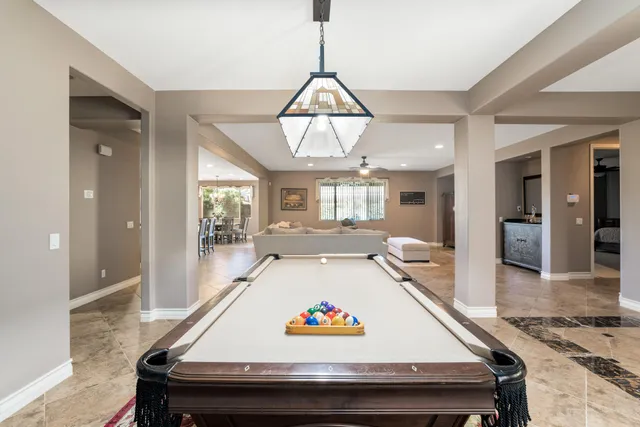 a sitting area with kitchen view and wooden floor