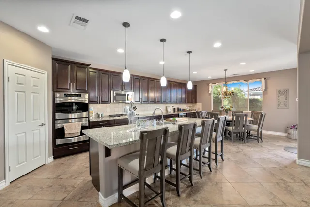a kitchen with cabinets and chairs