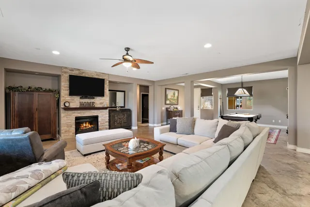 a living room with furniture a fireplace and a flat screen tv