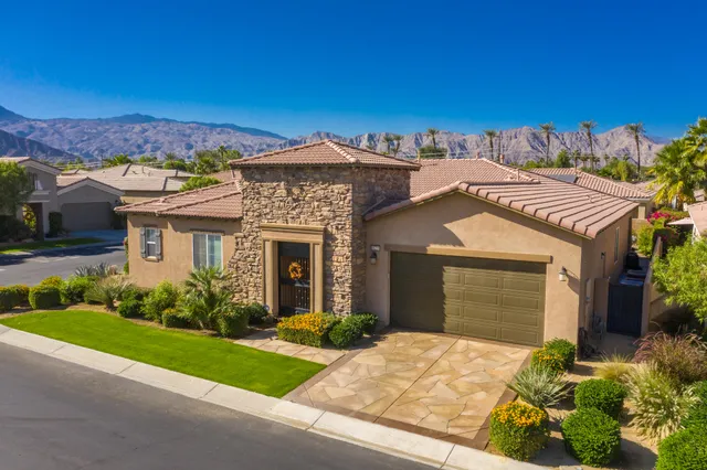 a front view of a house with a garden