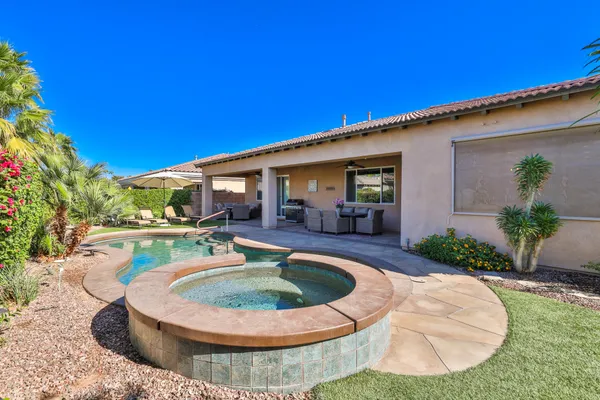 a view of a house with swimming pool and a yard