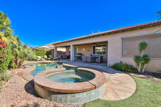 a view of a house with swimming pool and a yard