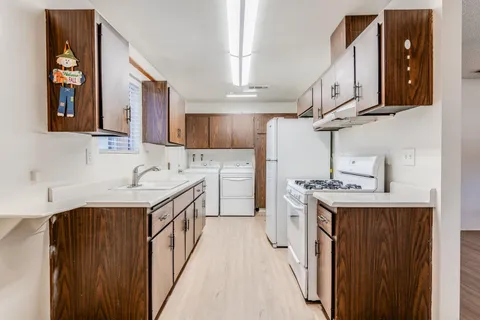 a kitchen with a sink stove and cabinets