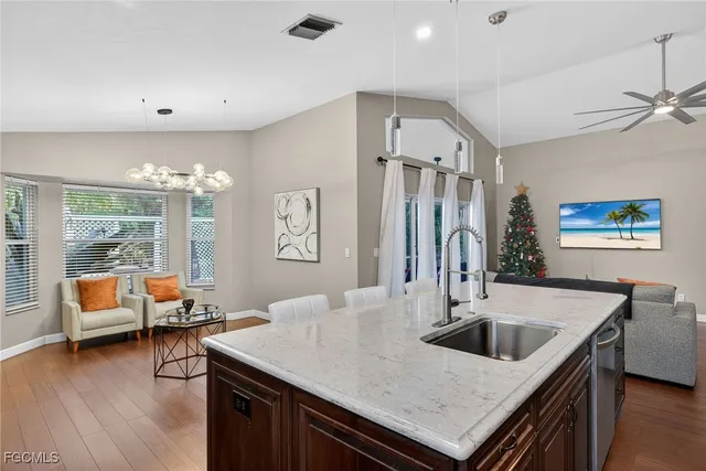 a kitchen with a table chairs and wooden floor