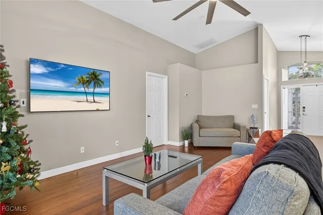 a living room with furniture and flowers