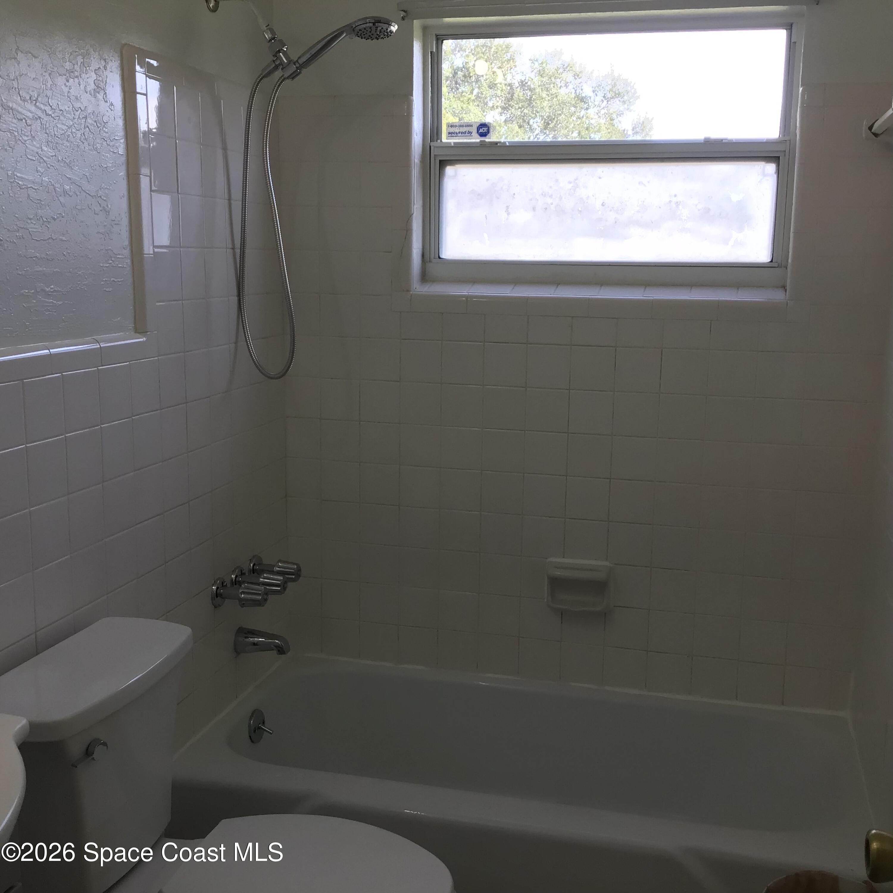 2360 Warwick Road Melbourne, FL 32935 - Photo 9 of 12 a bathroom with a shower and a toilet