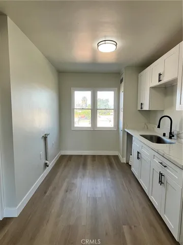 a kitchen with sink and cabinets