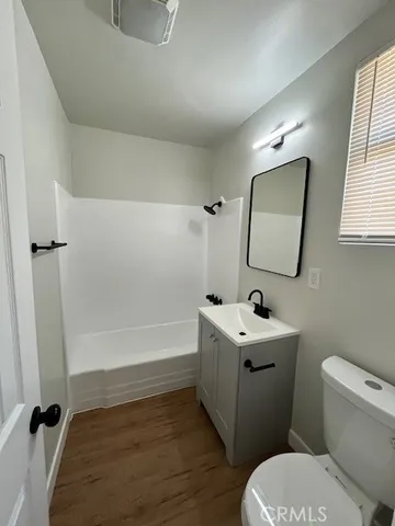 a bathroom with a sink toilet tub and mirror