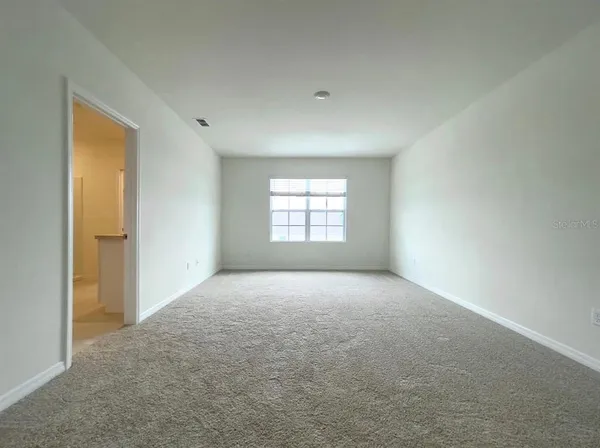 a view of an empty room with a window