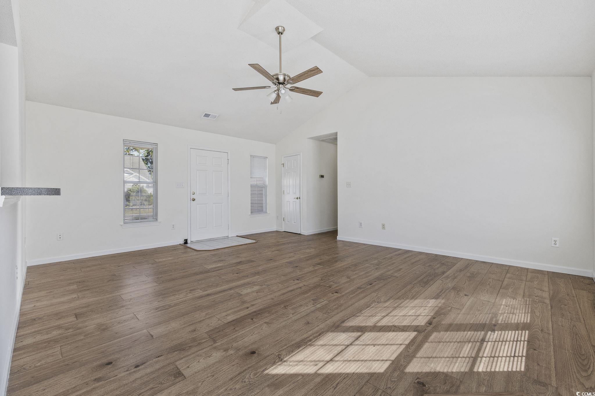133 Marsh Rabbit Drive Myrtle Beach, SC 29588 - Photo 4 of 33 Unfurnished living room with light wood-style flooring, a ceiling fan, and high vaulted ceiling