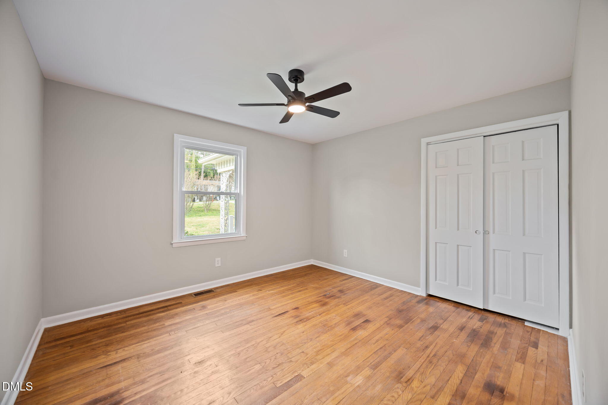 637 Buck Jones Road Raleigh, NC 27606 - Photo 10 of 32 an empty room with a window and a ceiling fan