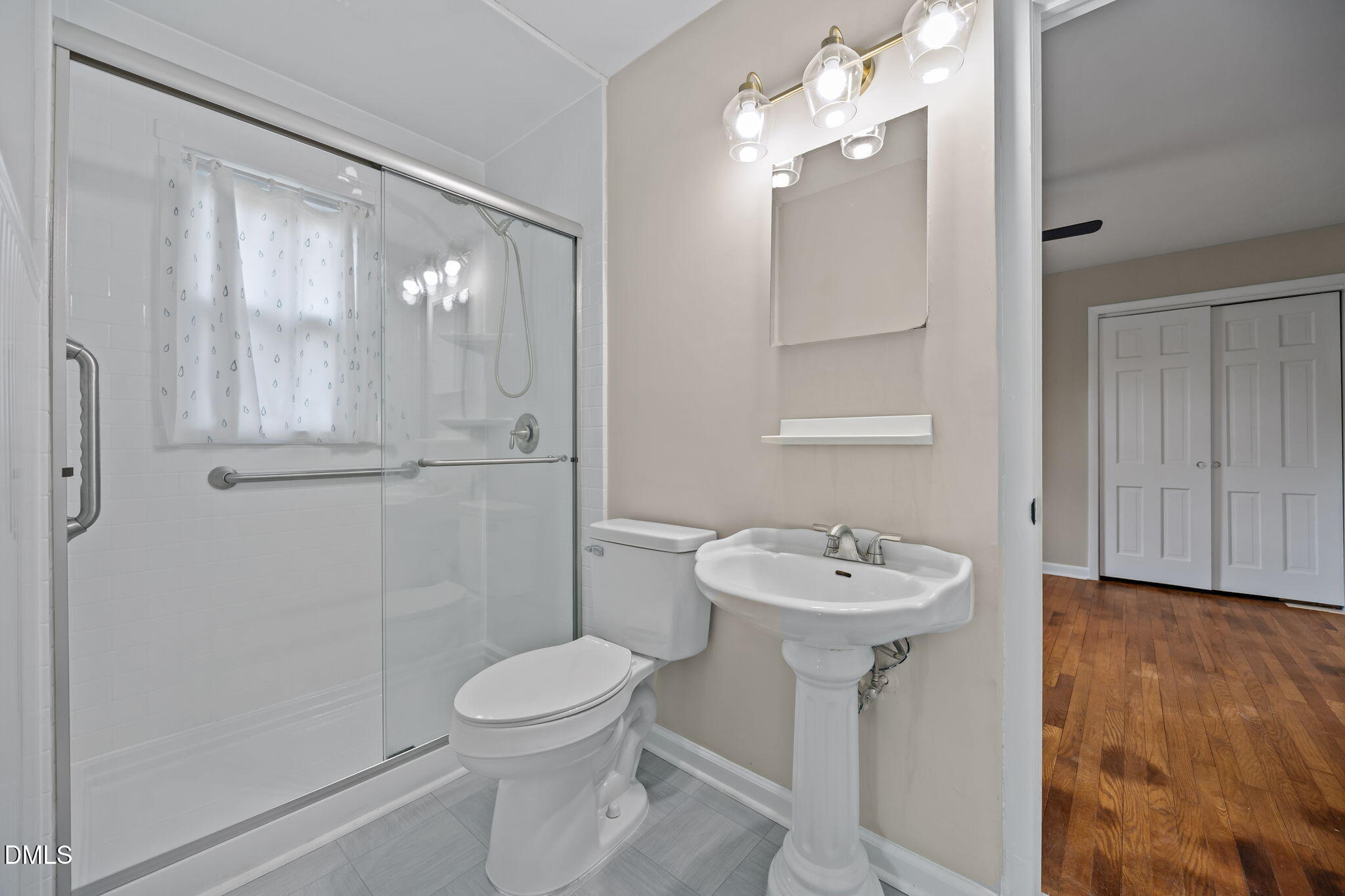 637 Buck Jones Road Raleigh, NC 27606 - Photo 11 of 32 a bathroom with a sink toilet and a mirror