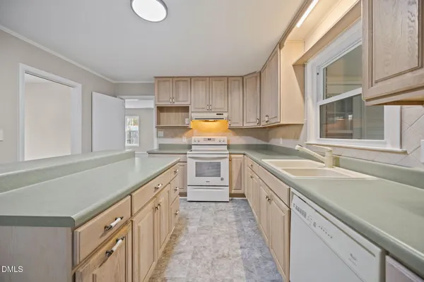 a kitchen with white cabinets and white appliances